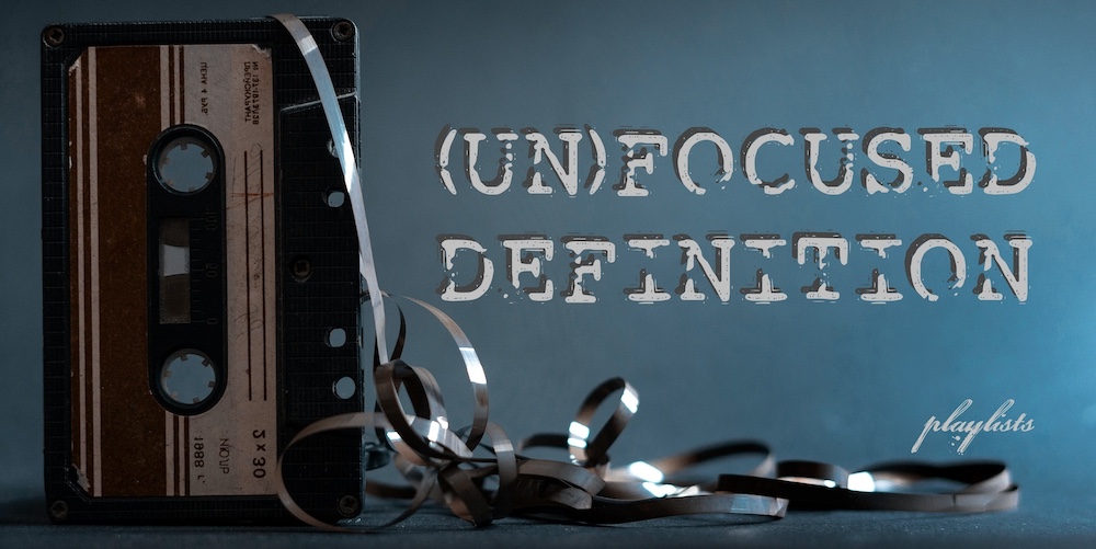 Old vintage cassette tape with tangled tape on a dark background