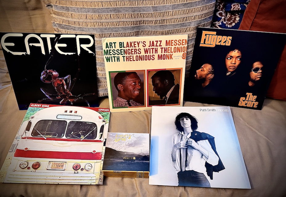 holiday 2025 - a small batch of vinyl records and a box set laying on my futon. We got some Eater, Henry Cow, Albert King, Patti Smith, Art Blakey with Thelonius Monk, and Fugees